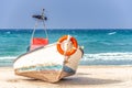 Old wooden boat on the Mediterranean sea with a life-saving circle on its nose Royalty Free Stock Photo