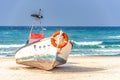 Old wooden boat on the Mediterranean sea with a life-saving circle on its nose Royalty Free Stock Photo