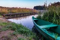 Old wooden boat in the reed bushes on the bank of wide river or lake Royalty Free Stock Photo