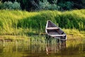 Old wooden boat on the river bank or clouds close up against the Royalty Free Stock Photo