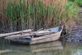 Old wooden boat on the river bank in early spring Royalty Free Stock Photo