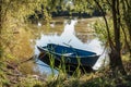 Old wooden boat on a river in the woods - nostalgic scene