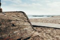 Old wooden boat upside down on the beach