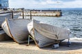 Old wooden boats on the shore on the city promenade