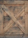 Old wooden box. selective focus on the X mark on a wooden door on a cowboy barn texture or background Royalty Free Stock Photo