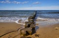 Old wooden breakwater. Baltic Sea. Sunrise over the sea Royalty Free Stock Photo