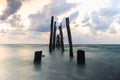 Old wooden bridge abandoned pier stumps at Thungsang bay in Thailand, Tropical beach seaside, White Balance effect