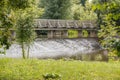 Old wooden bridge above floating river Royalty Free Stock Photo