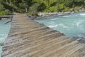 Old wooden bridge across mountain river. Altai Mountains, Russia Royalty Free Stock Photo