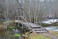 Old wooden bridge across the river Abdeh near the village of Gnilkino. Pskov region, Russia Royalty Free Stock Photo