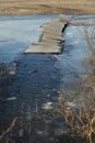 Old wooden bridge across the river collapsed and fell through the ice. Russia. Spring Extreme crossing the river Royalty Free Stock Photo