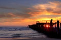 Old wooden bridge .Awesome colorful sunset in Lithuania on a sand dunes ..Baltic sea.