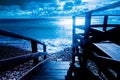 An old wooden bridge that descends to the Mediterranean Sea, filmed at a blue hour, Cagliari, Sardinia, Italy Royalty Free Stock Photo