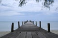Old wooden bridge extends into the sea. Royalty Free Stock Photo