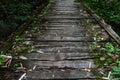 Old wooden bridge in forest. Ground view of bridge with wooden planks. Photography consisting of wooden bridge above river for Royalty Free Stock Photo