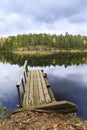 Old wooden bridge in a lake in autumn Royalty Free Stock Photo