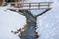 Old wooden bridge over a mountain river in winter, in Styria region, Austria Royalty Free Stock Photo