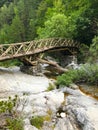 Old wooden bridge over mountain stream, Mount Olympus, Greece. Royalty Free Stock Photo