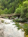 Old wooden bridge over mountain stream, Mount Olympus, Greece. Royalty Free Stock Photo