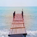 Old wooden bridge in the sea in a retro style Royalty Free Stock Photo