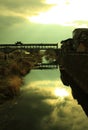 An old wooden bridge spans a river in Wuyishan