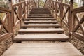 Old wooden bridge with stairs in forest. Staircase in the wood. Adventure and explore concept Royalty Free Stock Photo