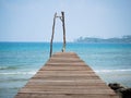 Old wooden Bridge to the blue sea Royalty Free Stock Photo
