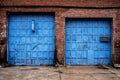 Old Wooden Bright Blue Garage Doors Abaondoned Brick Building