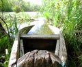 Old wooden broken boat for swimming on banks water in natural reeds Royalty Free Stock Photo
