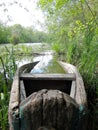 Old wooden broken boat for swimming on banks water in natural reeds Royalty Free Stock Photo