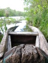 Old wooden broken boat for swimming on banks water in natural reeds Royalty Free Stock Photo