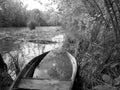 Old wooden broken boat for swimming on banks water in natural reeds