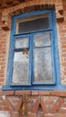 Smashed glass Window with old wooden frame on grunge wall damaged house Royalty Free Stock Photo