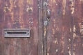 Old wooden brown door closed with a letterbox on it Royalty Free Stock Photo