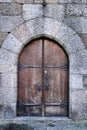 Old wooden brown door with wrought iron details