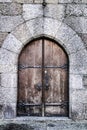 Old wooden brown door with wrought iron details Royalty Free Stock Photo