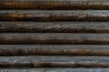 Old wooden brown gray wall made of round logs. Texture Russian building Royalty Free Stock Photo