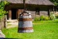 Old wooden bucket to draw water from the well in the field, Royalty Free Stock Photo