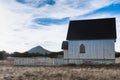 Old wooden building with white picket fence out front on the prairie. Royalty Free Stock Photo