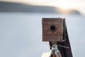 Old wooden camera. old camera on a tripod. Sunset by the sea Royalty Free Stock Photo