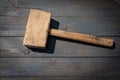 Old wooden carpenter's hammer on dark wood texture background Royalty Free Stock Photo