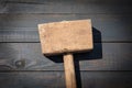 Old wooden carpenter's hammer on dark wood texture background Royalty Free Stock Photo