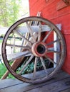 A old Wooden Carriage Wagon Wheel Next to a Barn on a Farm Royalty Free Stock Photo
