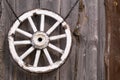 An old wooden carriage wheel hanging on the barn wall Royalty Free Stock Photo