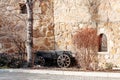 Old wooden cart against background of a strange stone wall of fortress Royalty Free Stock Photo