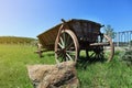 Old wooden cart in a green grass,wagon horse,Old wooden cart for Royalty Free Stock Photo