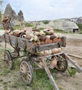 On an old wooden cart, a pile of clay jugs and pots Royalty Free Stock Photo