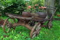 Old wooden cart with pink flowers Royalty Free Stock Photo