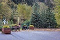 Old wooden carts and beautiful autumn flowers and trees by a railroad crossing Royalty Free Stock Photo