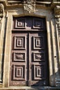 Old wooden carved brown door in Portugal